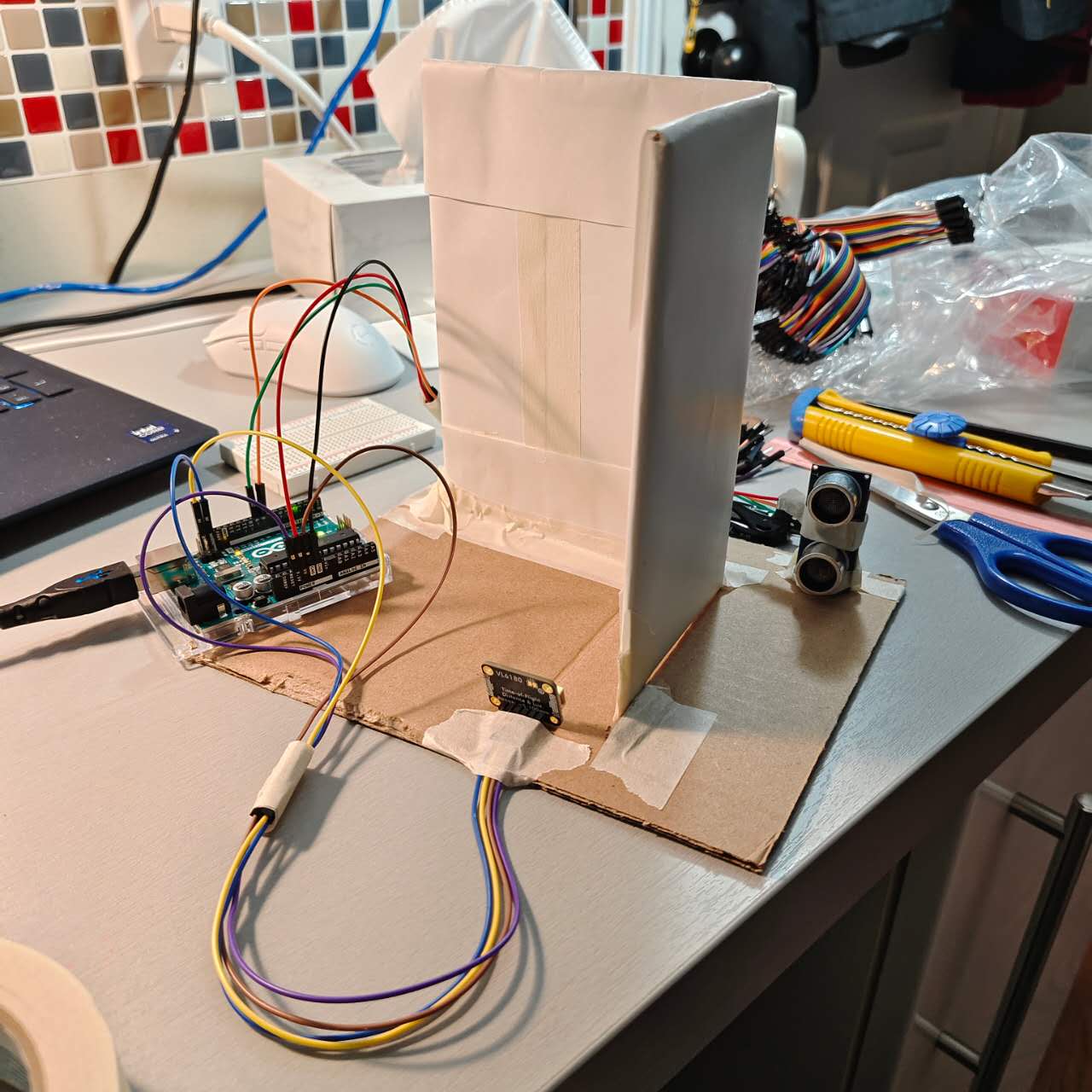 Two sensors were simulated and mounted on a paper model to replicate the effect of a user entering and leaving the premises.